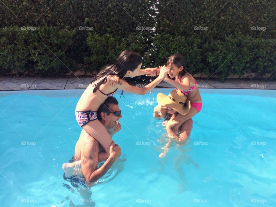Family having fun in the pool