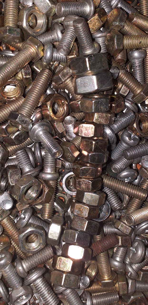 silver and gold colour steel nuts and bolts