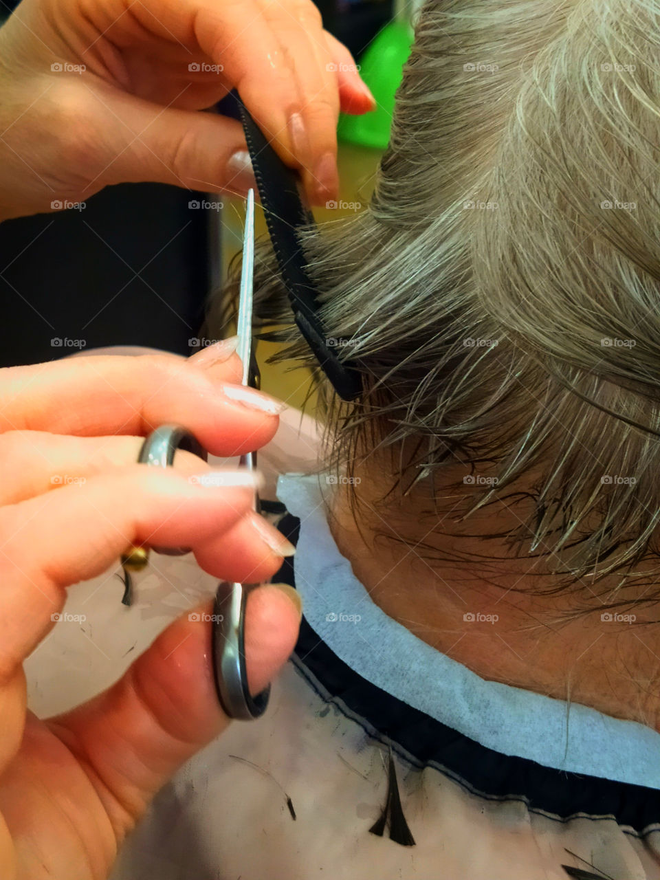 Scissors and calcination in the hands of a female hairdresser