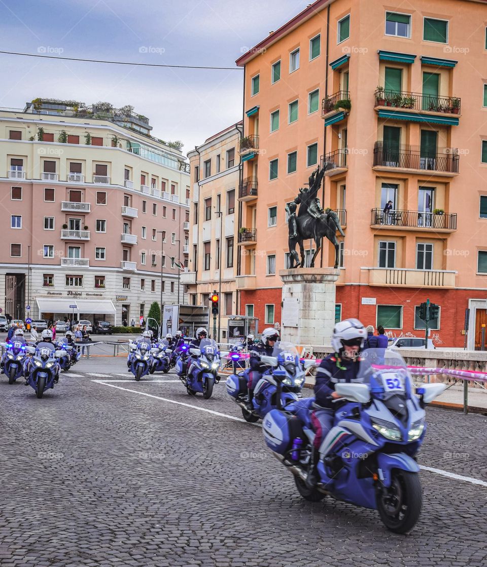 Police motorbikes riding along a street in Verona
