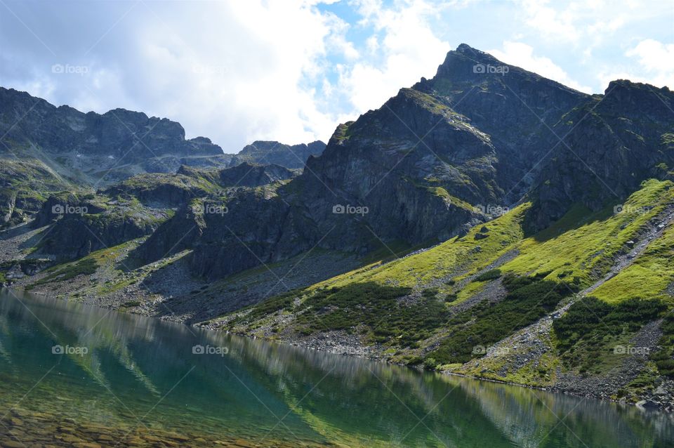 Reflection of rocky mountains on lake