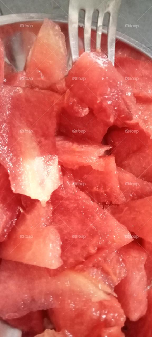 Watermelon has high water containt. this is inside red colour, crunchy, sweet, tasty delicious fruit. watermelon is circle or oval shaped. This fruit is summer Snacks.