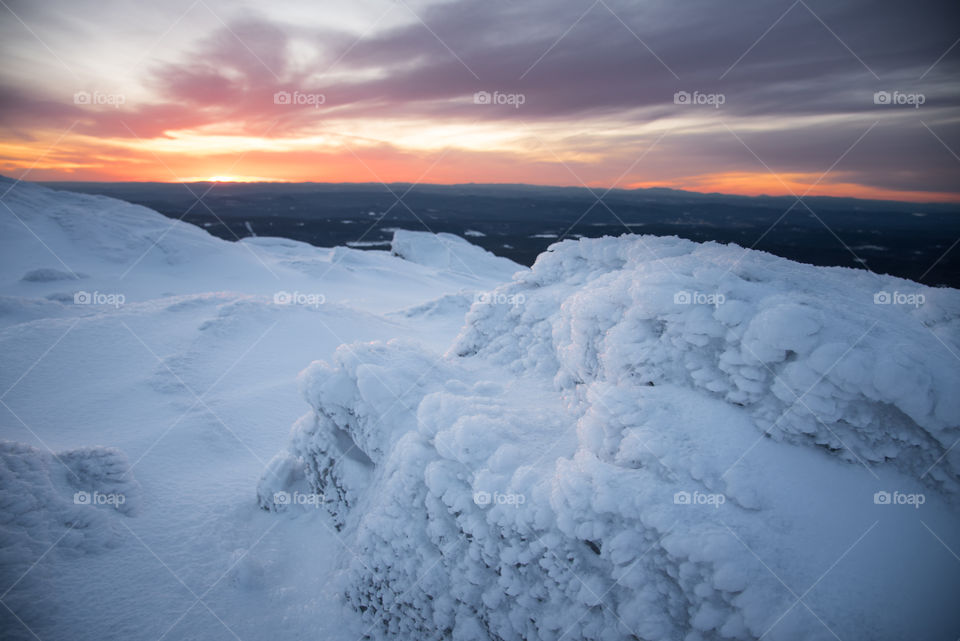 The water freezes in interesting patterns under the extreme conditions on a mountains peak