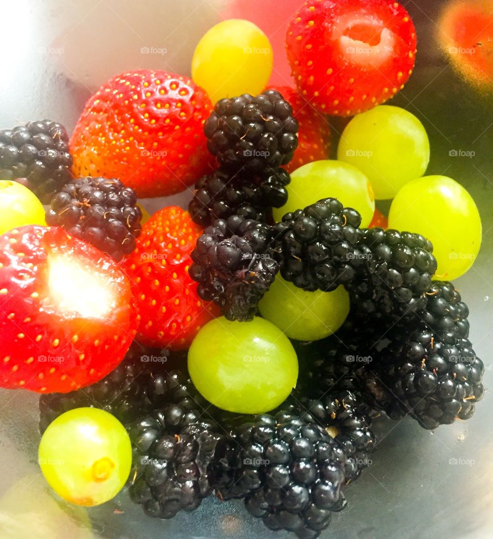 Close up of strawberries, blackberries and green grapes