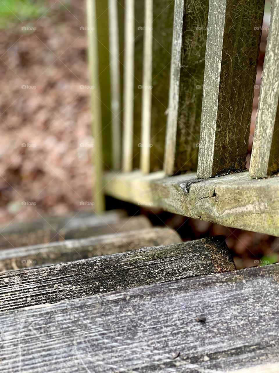 Wooden steps and balusters. The vanishing perspective descends into blurred focus.