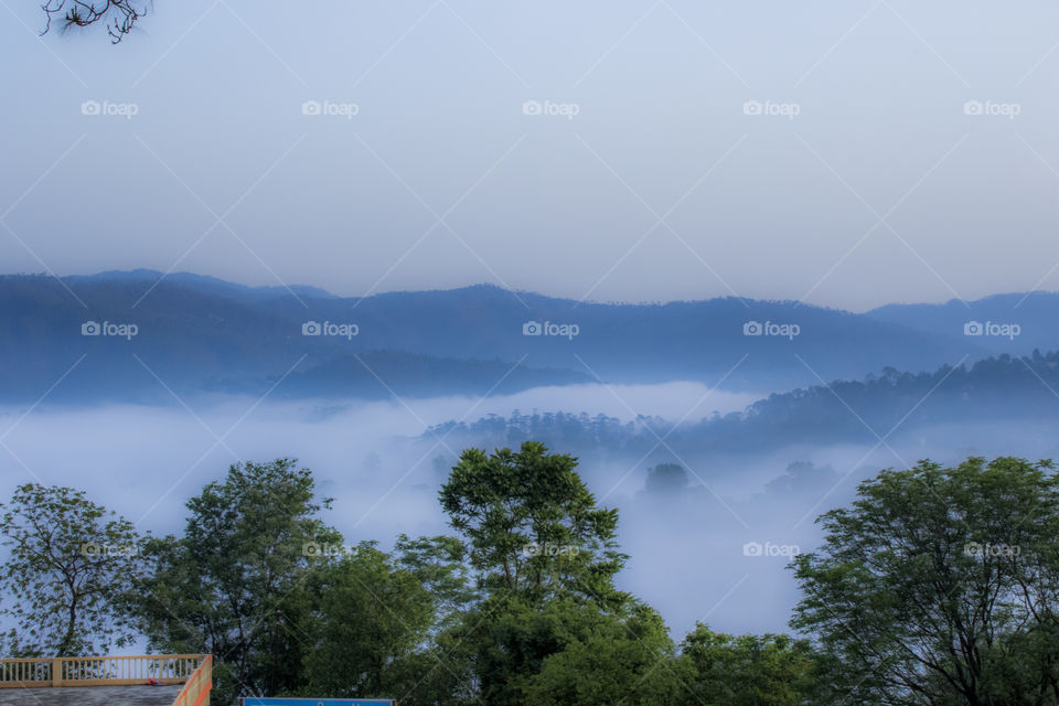 high altitude mountain with morning fogg