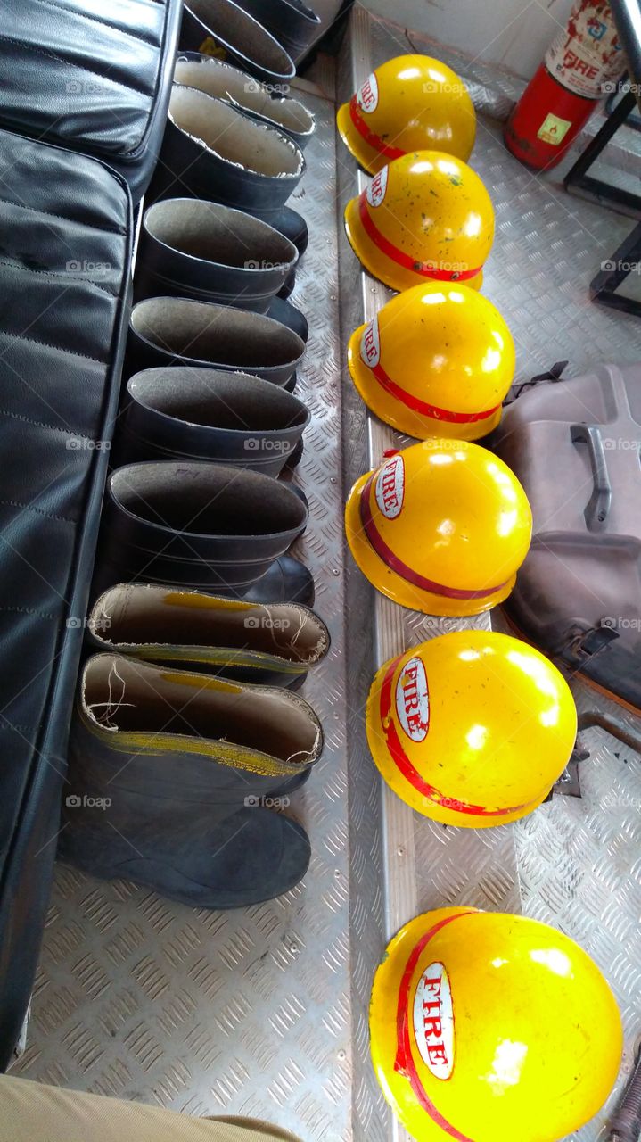 Firefighters shoes and helmet in a row