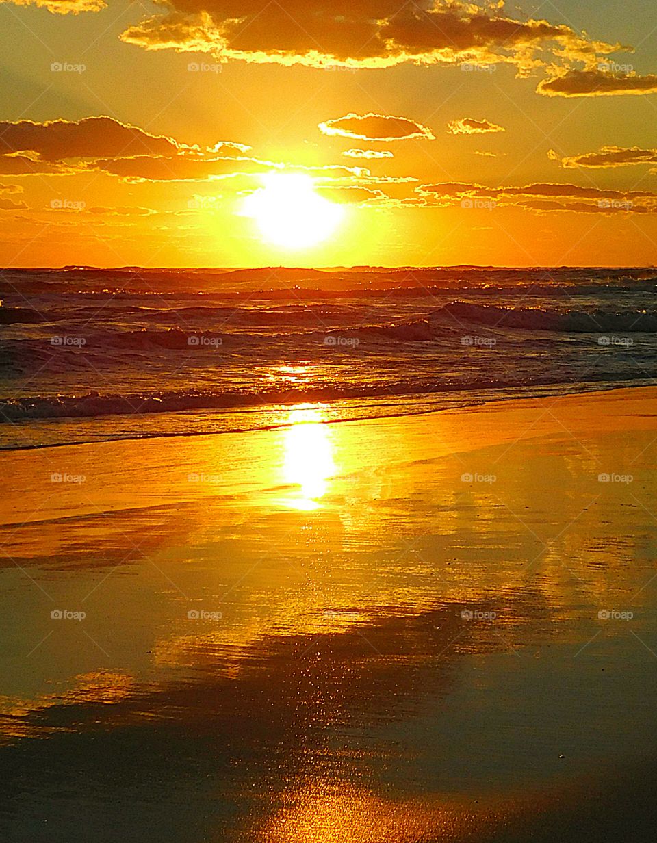 The yellow ball of fire changed to hues of orange, and then almost tangerine. The orange gold stretches far and wide over the Gulf of Mexico. Mother Nature has entertained me with another spectacular sunset.” 