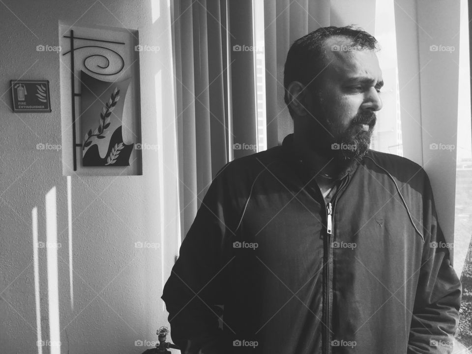 Portrait of beard man in jacket standing at home