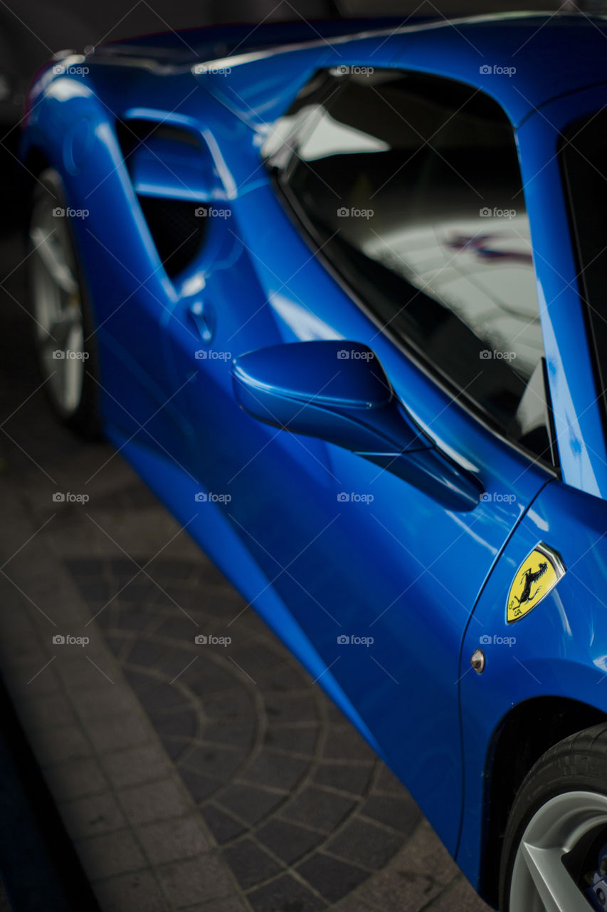 Blue Ferrari 488 spider coupe sports car 3.9 liter V8 twin turbo charged  (F154CB V8) close up side logo