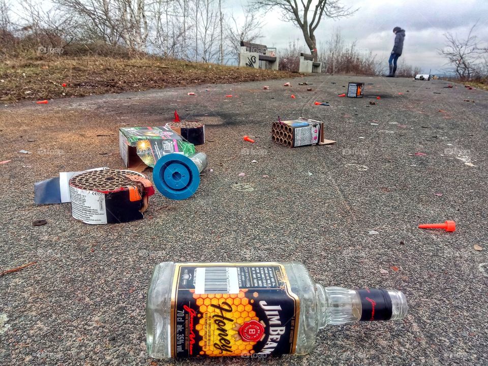 Cleaning up fireworks after New years eve and a Jim Beam Honey Bottle
