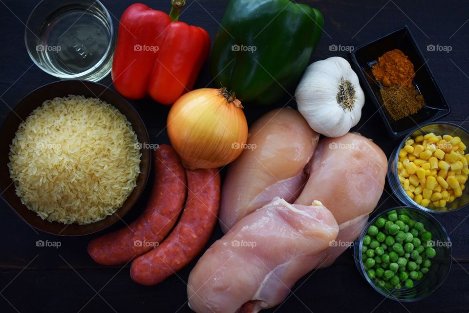 Ingredients for Cuban yellow rice with chicken, sausage and vegetables 