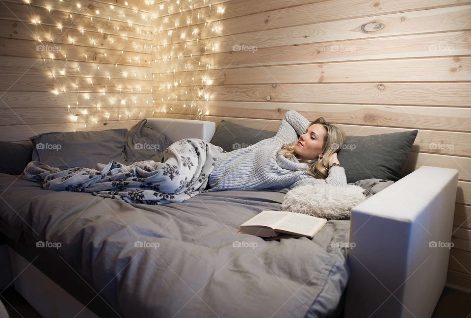 Woman with book relaxing on the couch