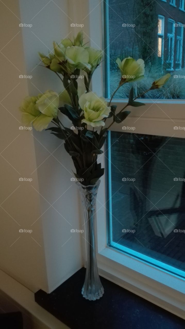 A tall vase with flowers