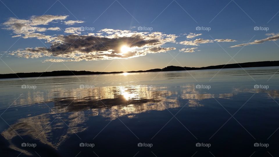 Sun behind clouds shining through