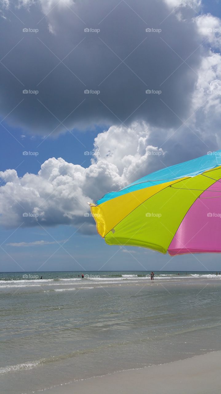Beach Umbrella. New Smyrna Beach showing an angry cloud.
