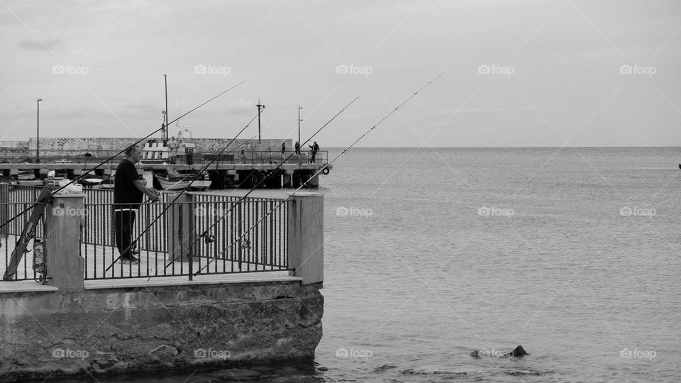Solitary man fishing in an quiet autumn day