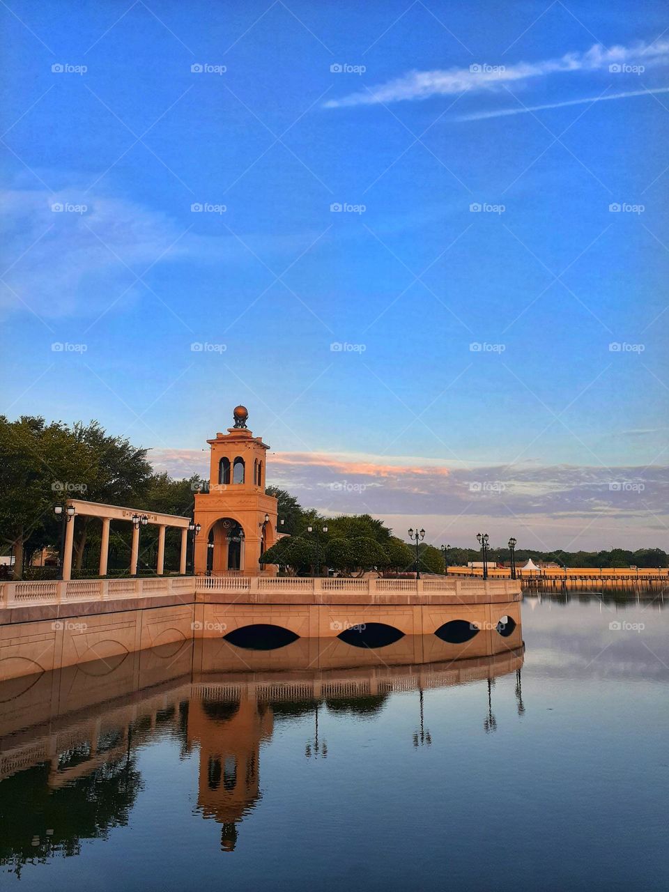 A landscape photo of the boardwalk and Lake with blue sky at Cranes Roost Park in Altamonte Springs, Florida.