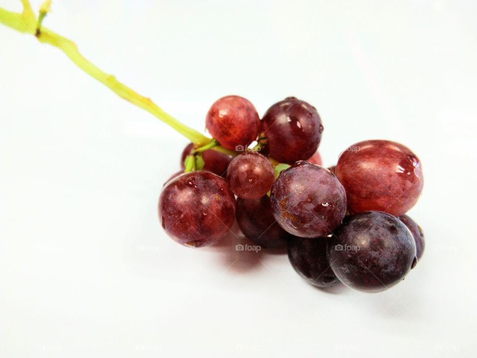 Seedless grapefruit isolated on white background.Water drop on fresh purple grape.