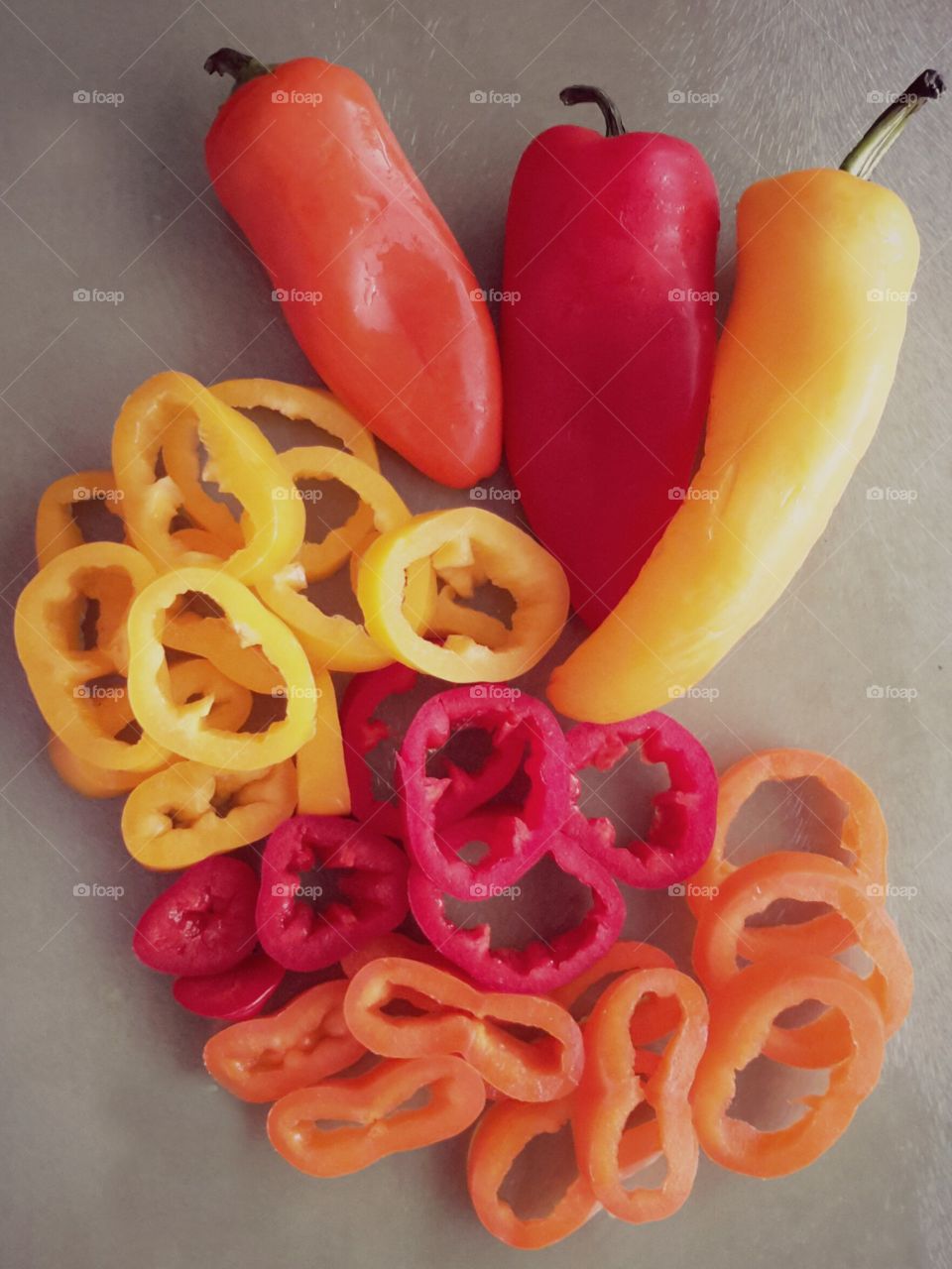 Colorful sliced and whole sweet peppers