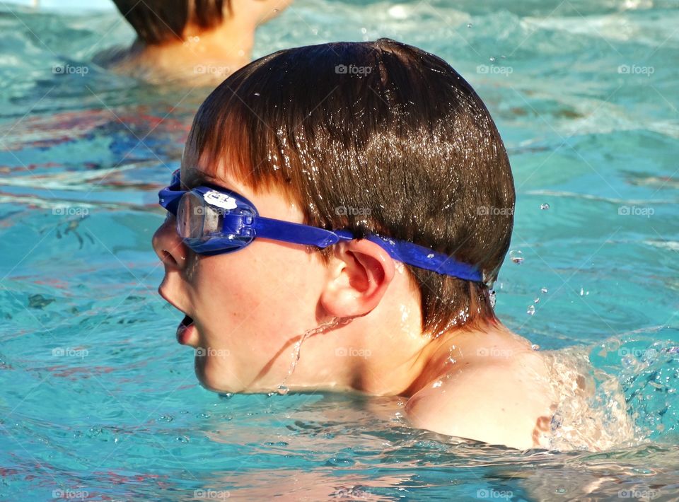 Young Swimmer. Young Boy Swimming Laps In A Pool
