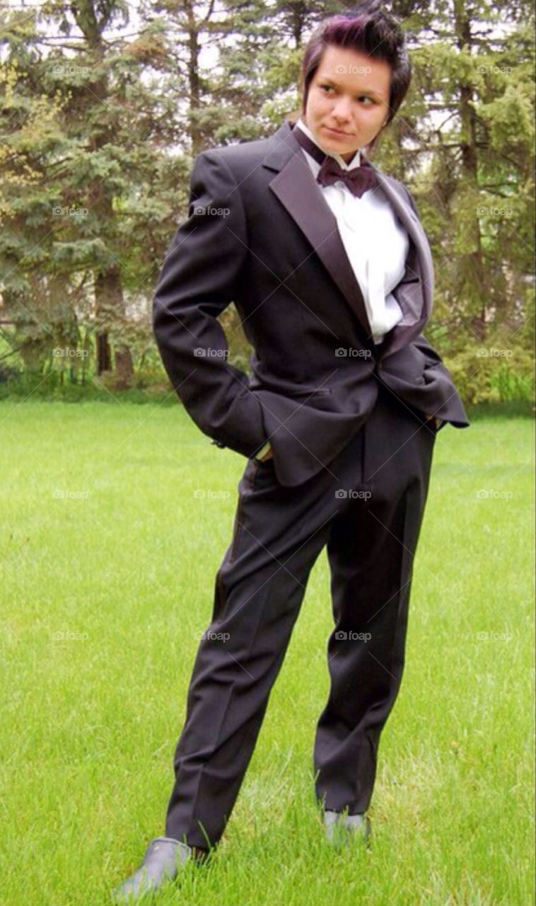 Prom : teenage girl in tuxedo. Young teen girl wearing a tux to prom , rebellious statement . Call me James , James Bond.