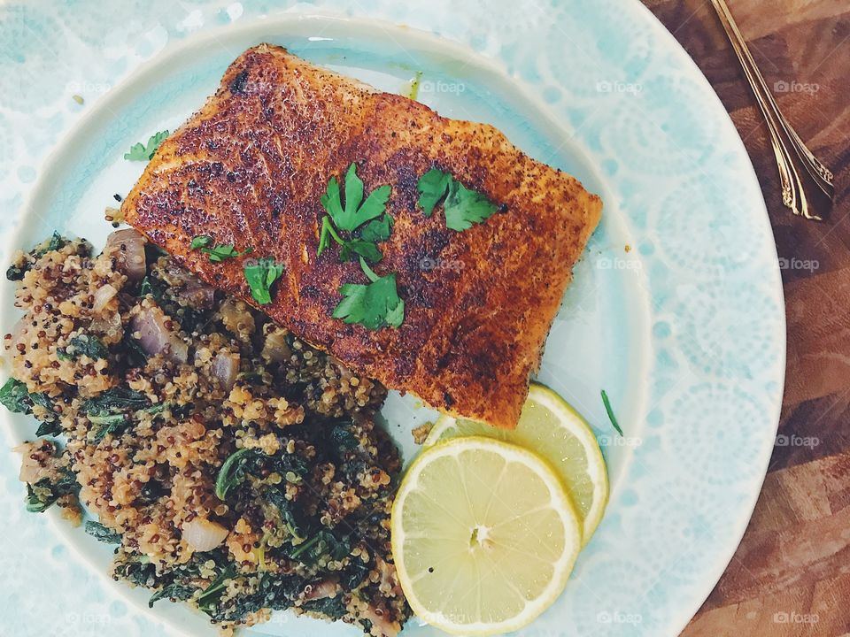 Fresh and delicious salmon and quinoa dinner complete with fresh parsley and lemon slices!