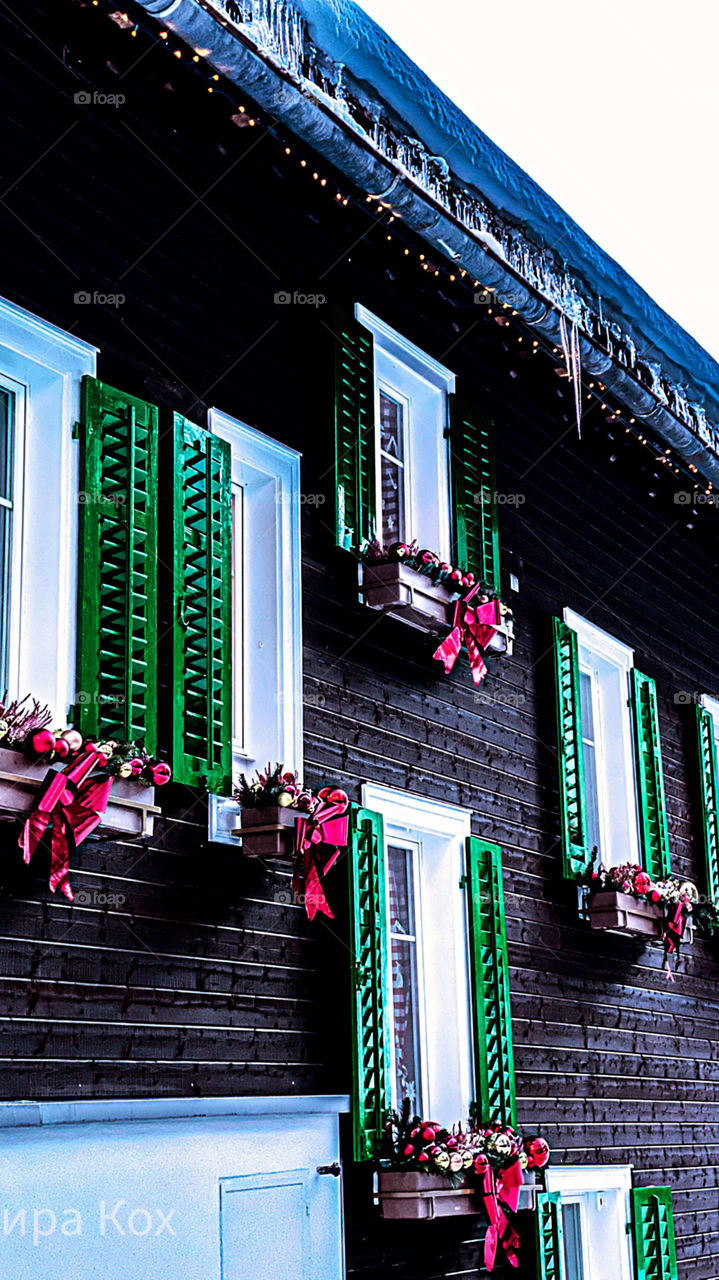 old house in Switzerland, windows, decorated house, New Year's house, New Year's toys, fairy house, icicles on the roof
