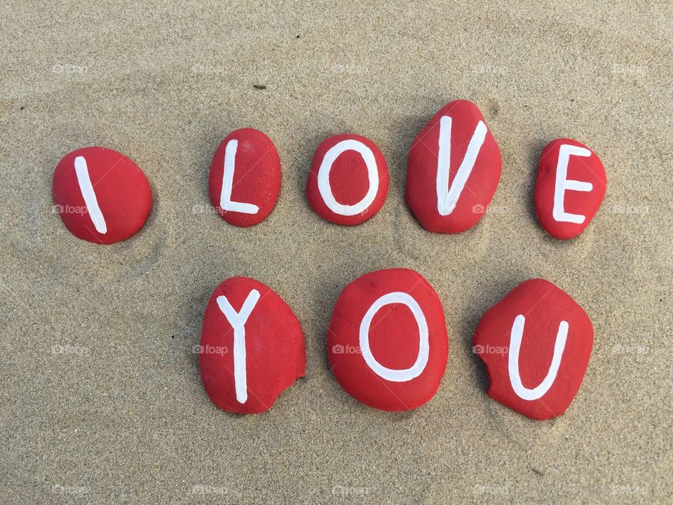 I love you, red stones on the sand 