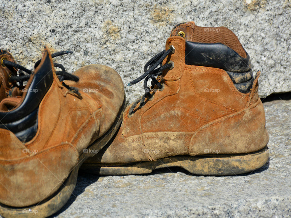 The boots were old. The leather had since cracked and aged. The toes were scuffed and they were falling apart at the seams. The boots had long lived their life of travel,work,joy, and love. After their final journey, it was time to throw them away. It was hard to say GOODBYE!