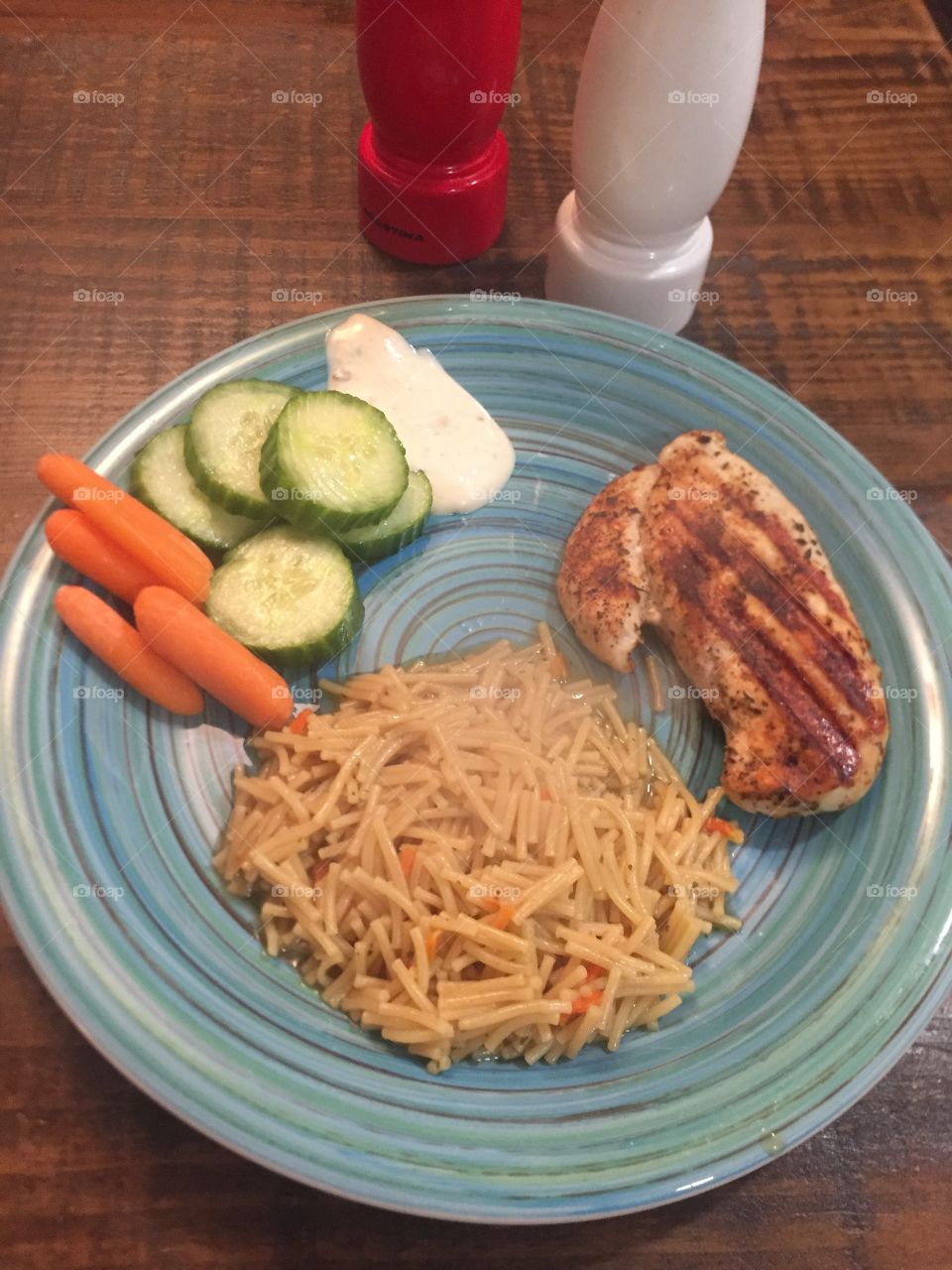 This is a great meal grilled chicken with blackened chicken spice honey garlic noodles Raw vegetables Definitely a winner in my house.