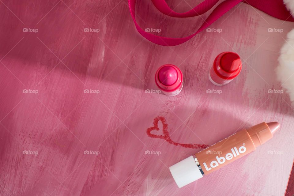 Labello smile - three shades of Labello tinted lip moisturizer high angle view flat lay with fun smile and heart