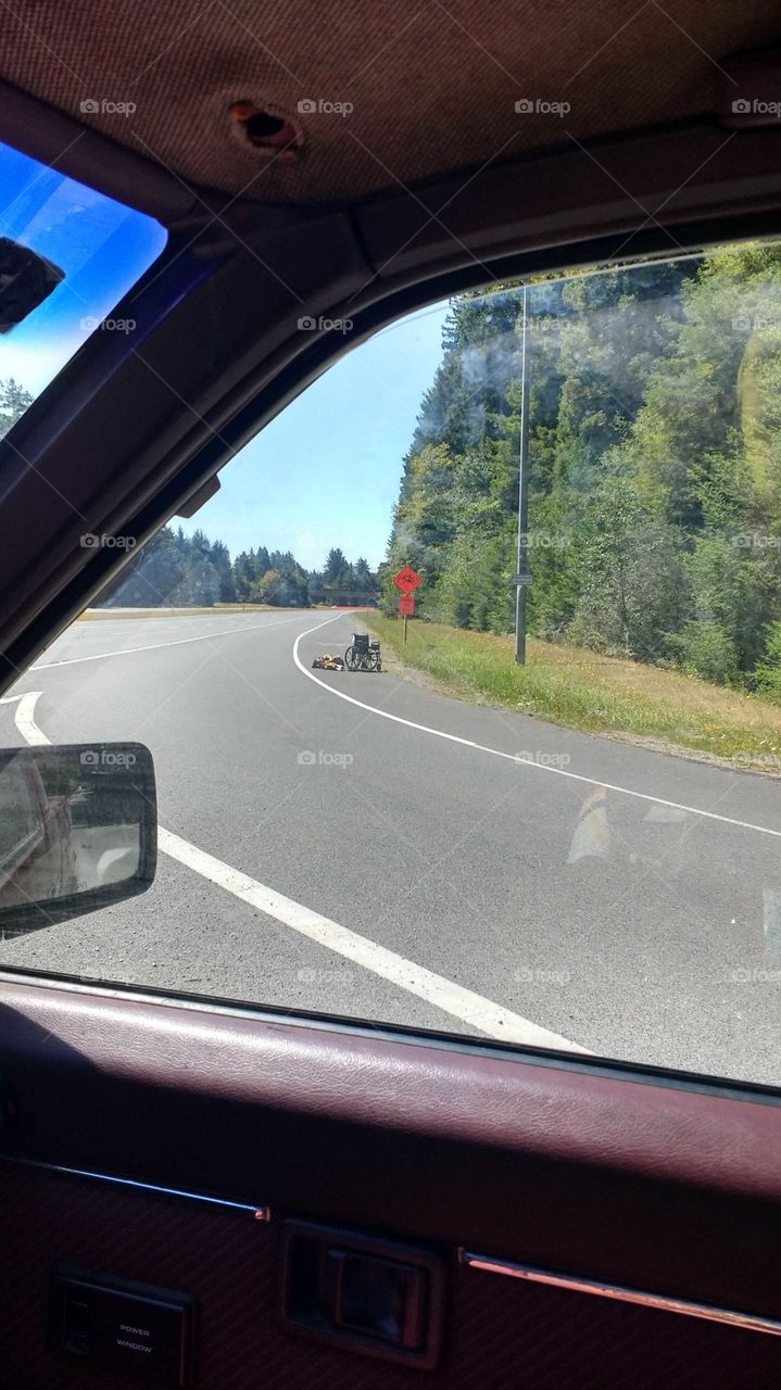 wheelchair and a woman laying on the HWY
