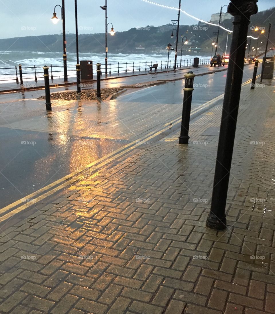 Street lights reflecting in puddles 