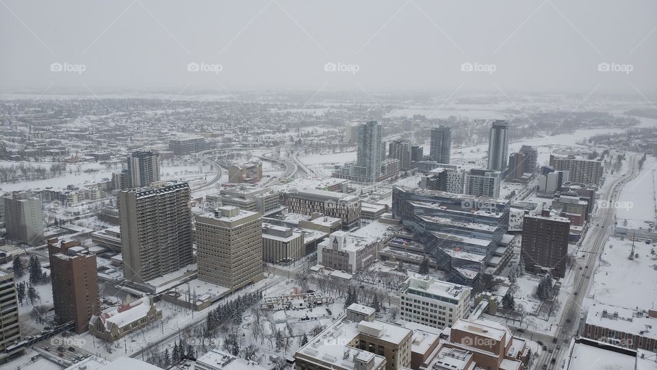 View from up high of snow covered downtown city of Calgary, Alberta, Canada. Buildings and streets, landscape in wintertime.