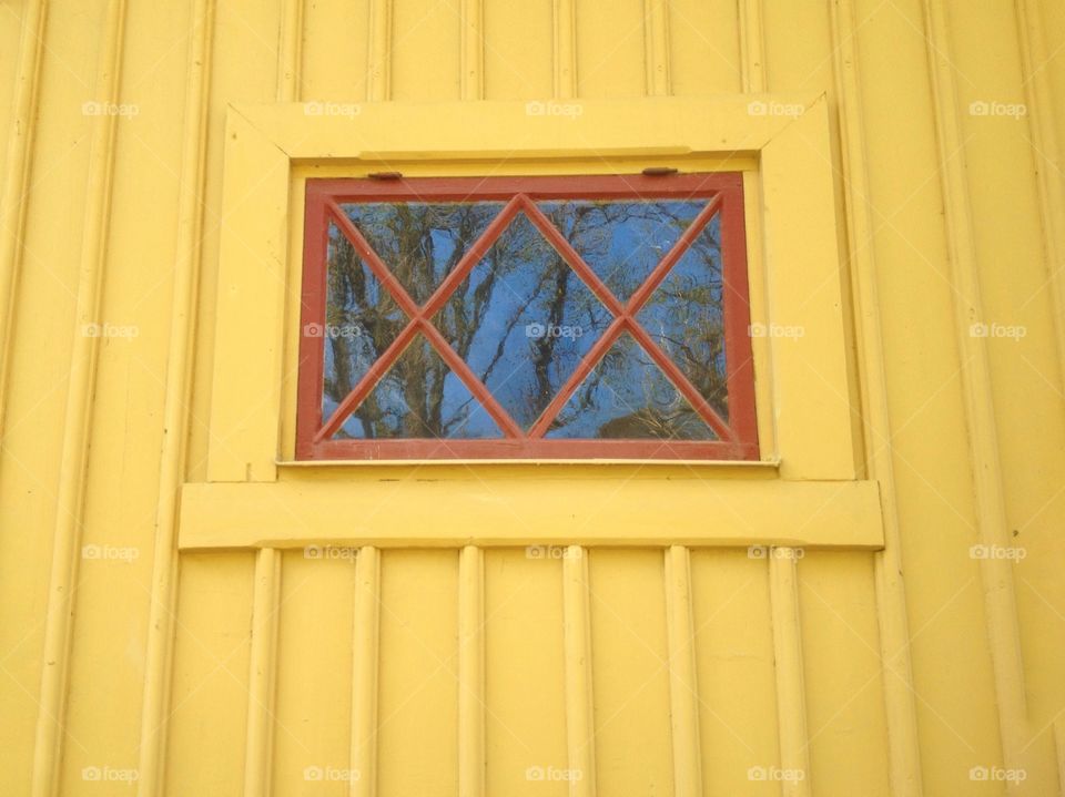 Window on yellow wall