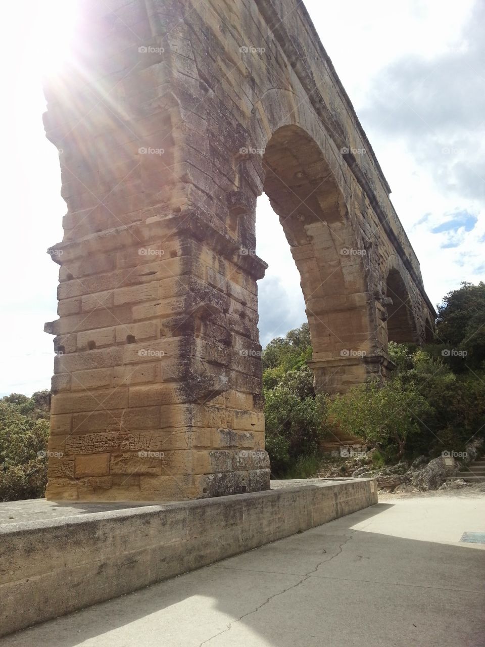 The sun shining through the aquaduct in the South of France