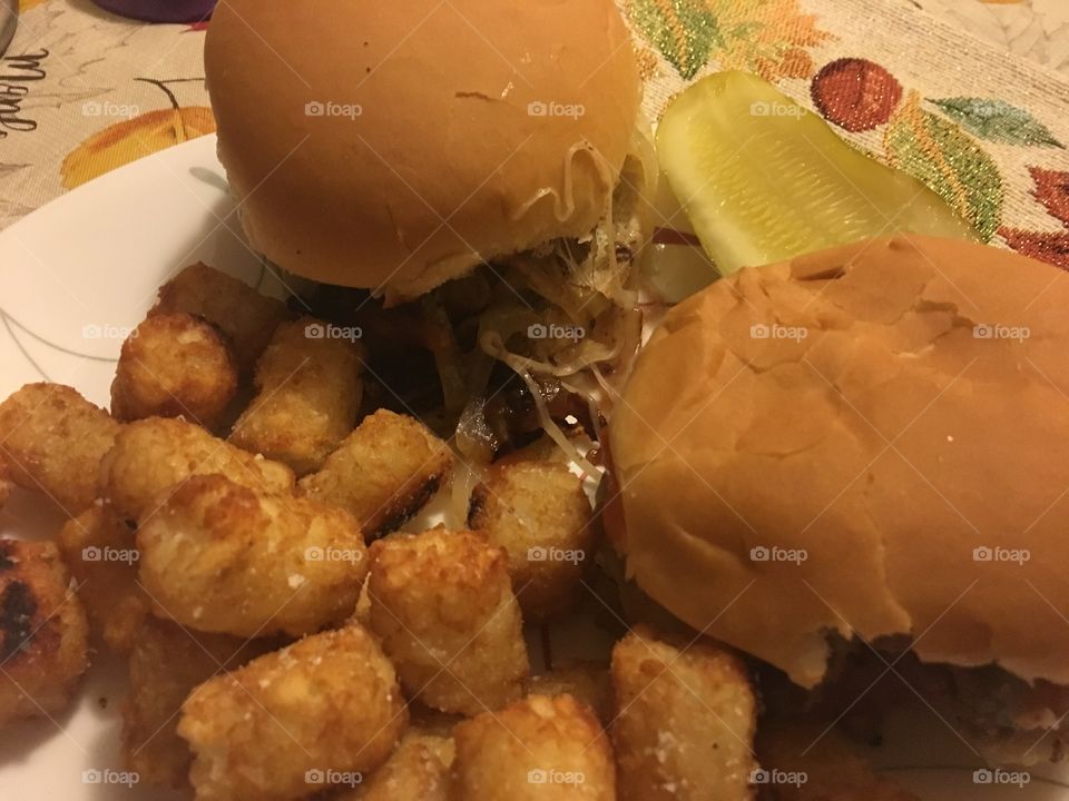 Burgers tator tots and a pickle 