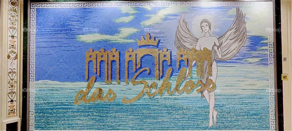 This is the highly imaginative sign for “das Schloss”, “the Castle”, a large multistory shopping mall in “Berlin”, Germany in the “Steglitz” district not far from the botanical garden. 2024. Hypnotic Productions