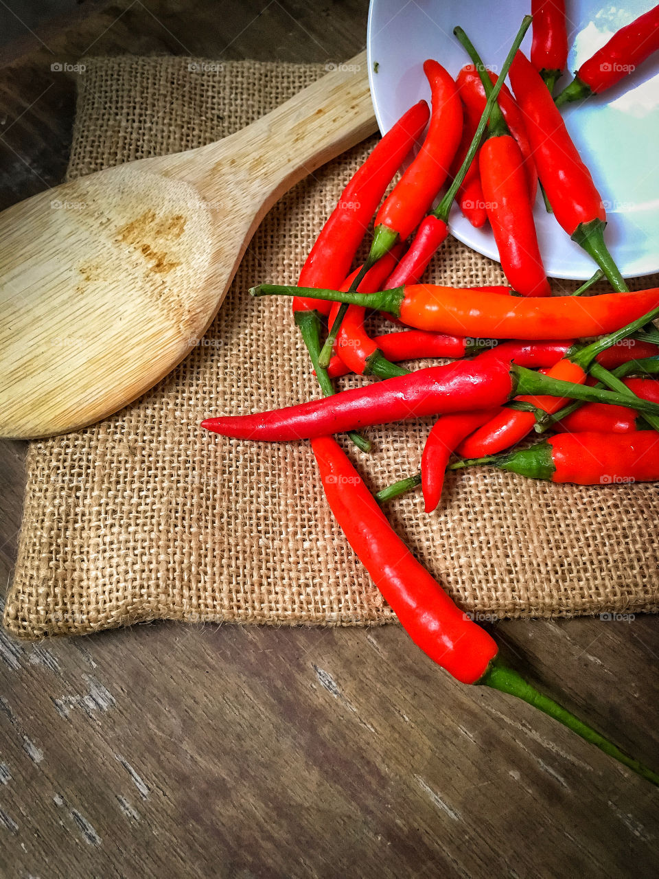 Red chili pepper on the wooden table.