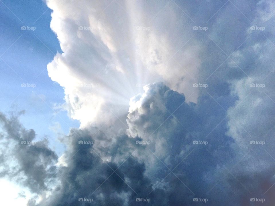 Sunrays through blue clouds. Sunrays through blue clouds