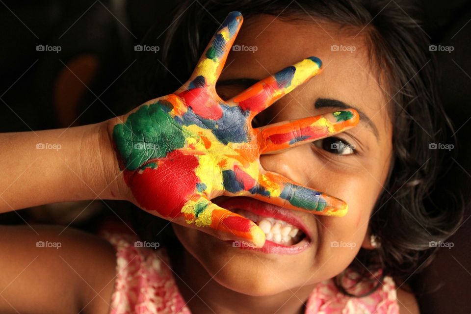 baby girl hand palm full of colours