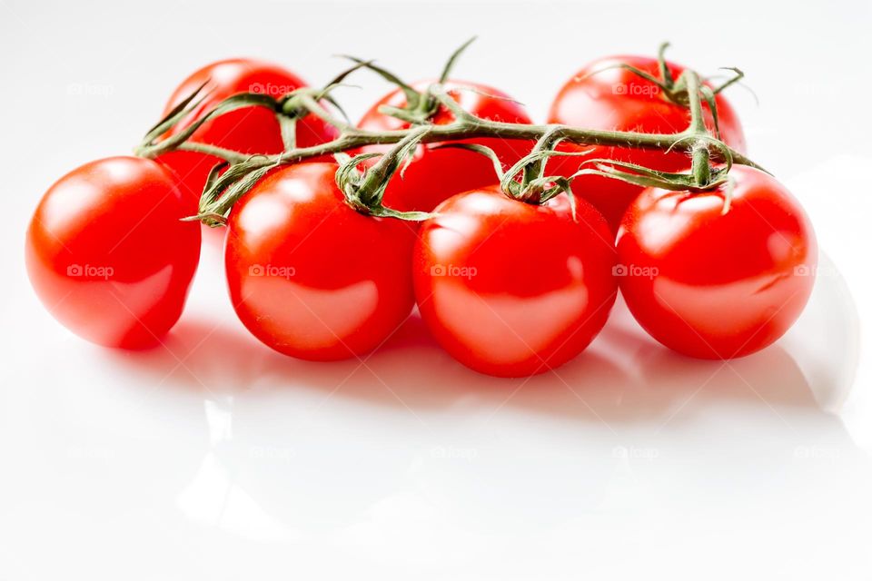 Organic freshly harvested bunch of cherry tomatoes, closeup