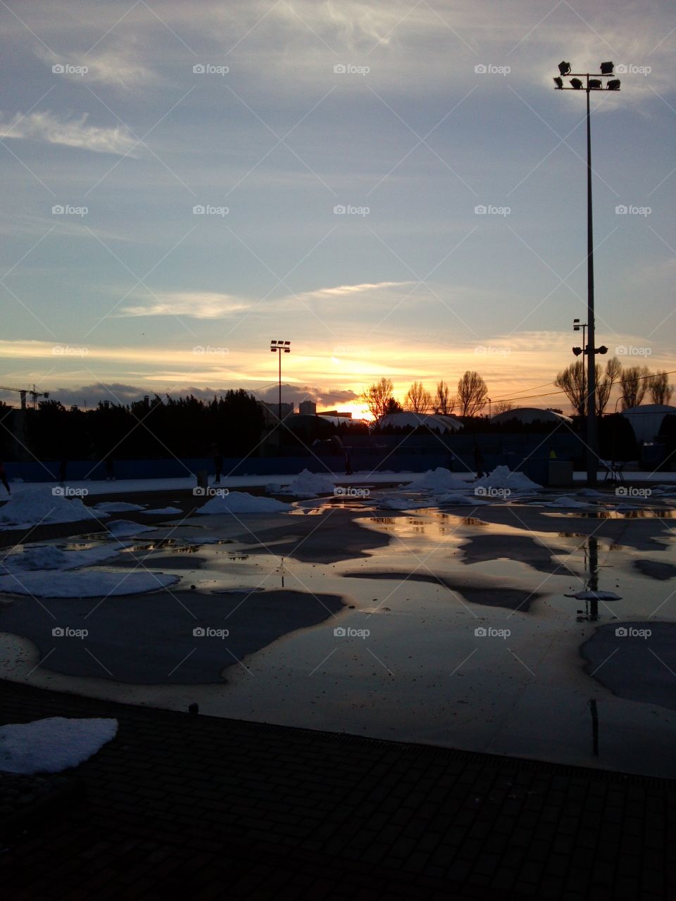 sunset over ice skating ring