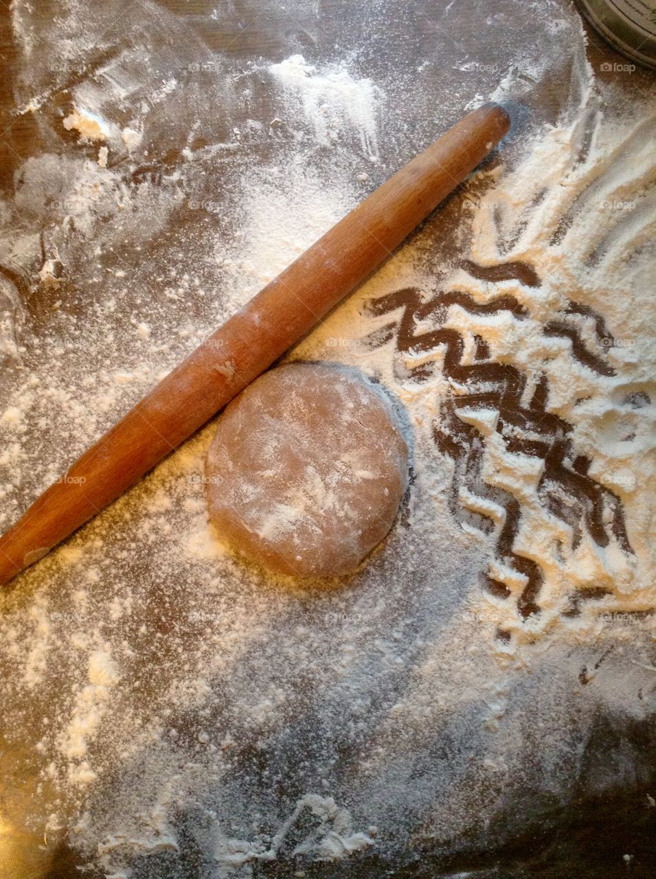 Dough and a cart on the table with flour