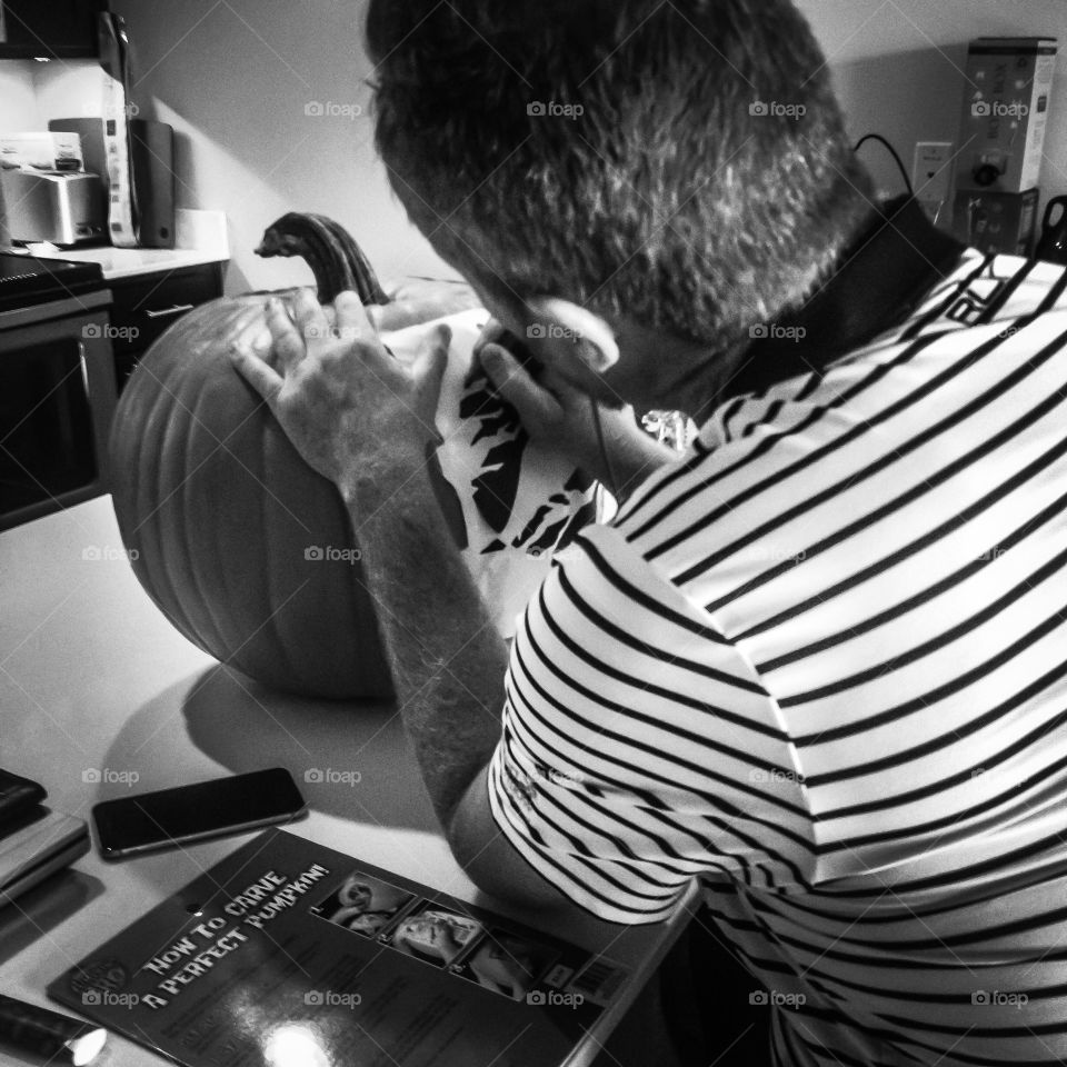 my friend hard at work carving a pumpkin for me. His first one ever 46 years old and did it with power tools and dot art.