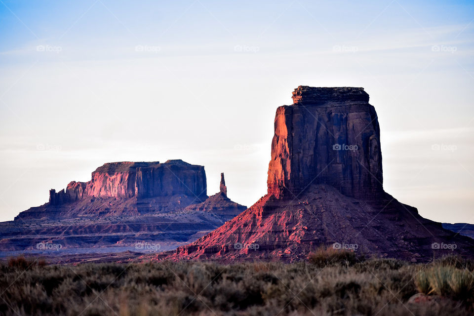 Sunset reflects on the red rocks of Monument  Valley at sunset, bringing out some beautiful reds and purples. 