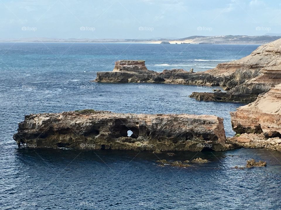 Ocean view from the cliffs, rock with hole, island, Australian coast, beach