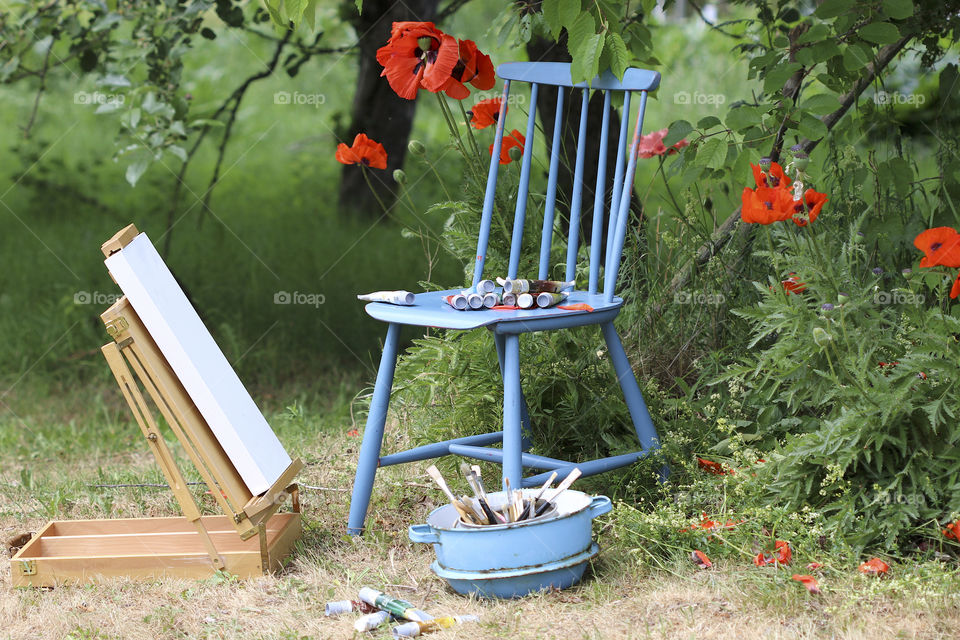 red poppy, blue chair and painted painting