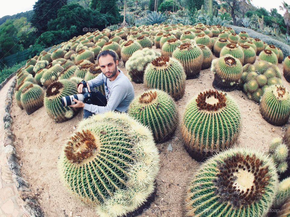 Man sitting on the cactus plantation 